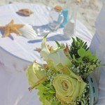 A table with flowers and shells on it