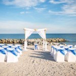 A beach wedding with blue and white decor
