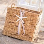 A basket with a bow on top of the beach.