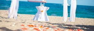 A table with a white cloth on it at the beach