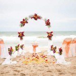 A beach wedding with flowers and chairs
