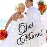 A couple holding a parasol that says Just Got Married