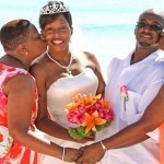 A bride being kissed and hugged by her parents