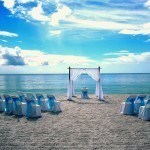 A beach with chairs and an arch in the sand