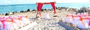 A wedding arch on the beach with flowers