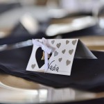 A place setting with name cards and hearts.