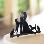 A cake topper of an angel with cats and dogs.